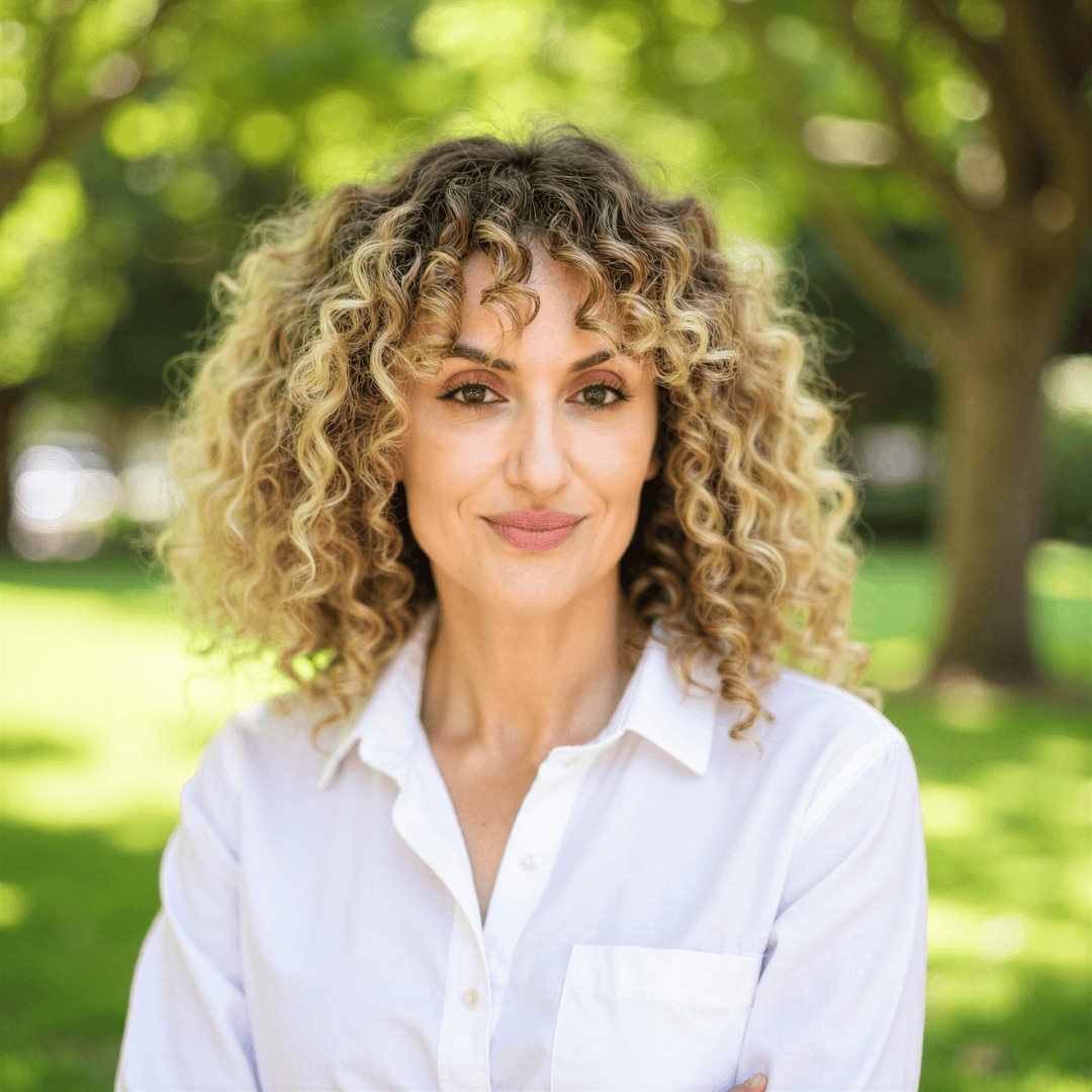 Smiling woman with curly hair outdoors