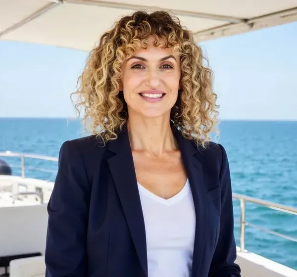 Smiling woman on boat with ocean background